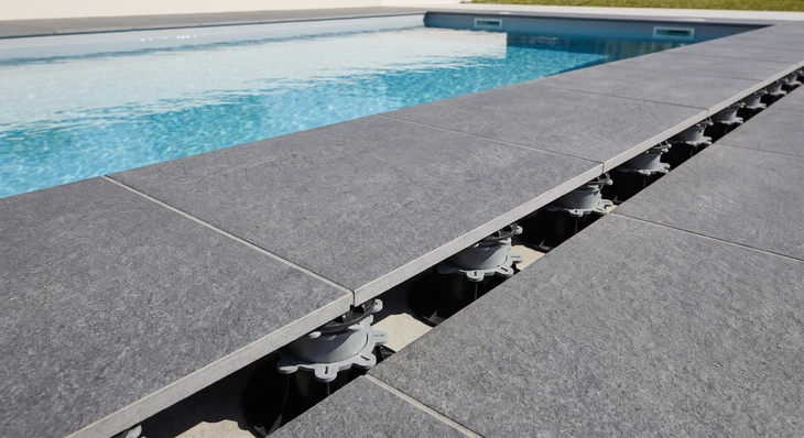 Piscine extérieure à fond coquille en béton projeté, forme libre, revêtement intérieur blanc, eau turquoise